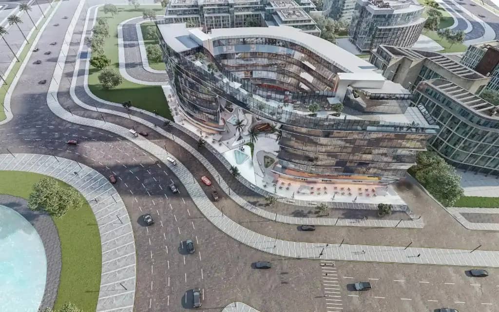Aerial view of Spark Capital Insights with curved mixed-use buildings and multilane roads